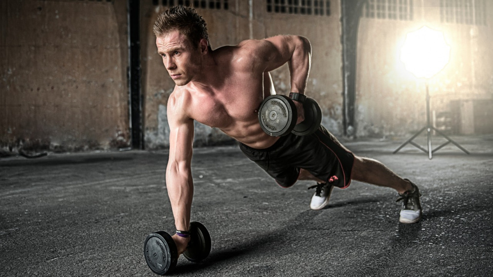 Athlete training with dumbbells